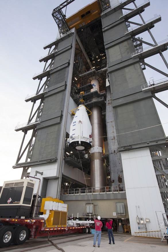 NASA's MAVEN (Mars Atmosphere and Volatile EvolutioN) spacecraft, inside a payload fairing, is hoisted to the top of a United Launch Alliance Atlas V rocket at the Vertical Integration Facility at Cape Canaveral Air Force Station's Space Launch Complex 41.
