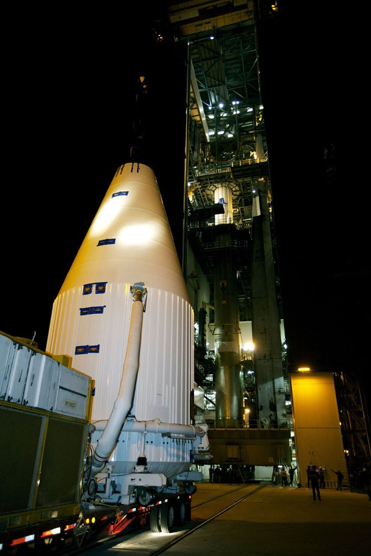 A transporter moves NASA's MAVEN spacecraft, inside a payload fairing, to the Vertical Integration Facility at Launch Complex 41 where it will be hoisted atop a United Launch Alliance Atlas V rocket that will boost it into space and on to Mars.