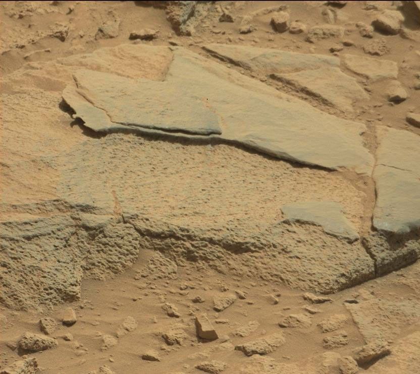 The rock "Ithaca" shown here, with a rougher lower texture and smoother texture on top, appears to be a piece of the local sedimentary bedrock protruding from the surrounding soil in Gale Crater.