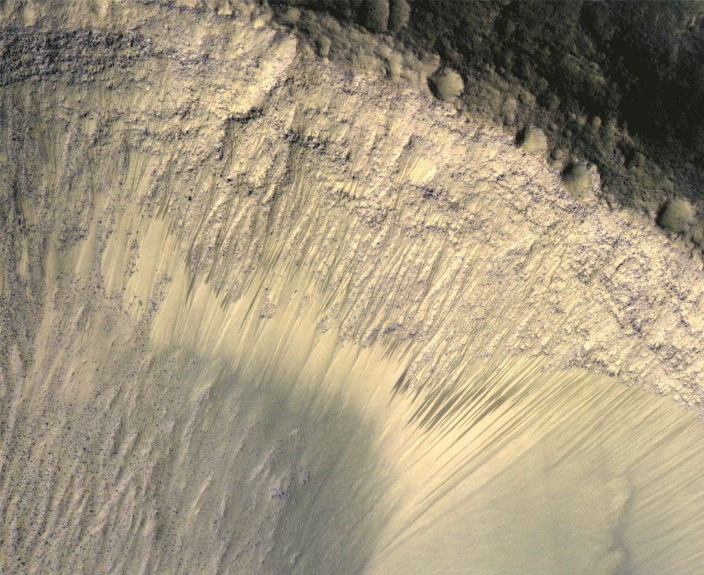 These images from the High Resolution Imaging Science Experiment (HiRISE) camera on NASA's Mars Reconnaissance Orbiter show how the appearance of dark markings on Martian slope changes with the seasons.