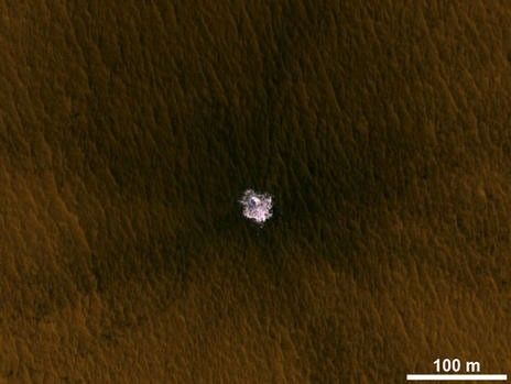 A meteorite impact that excavated this crater on Mars exposed bright ice that had been hidden just beneath the surface at this location.