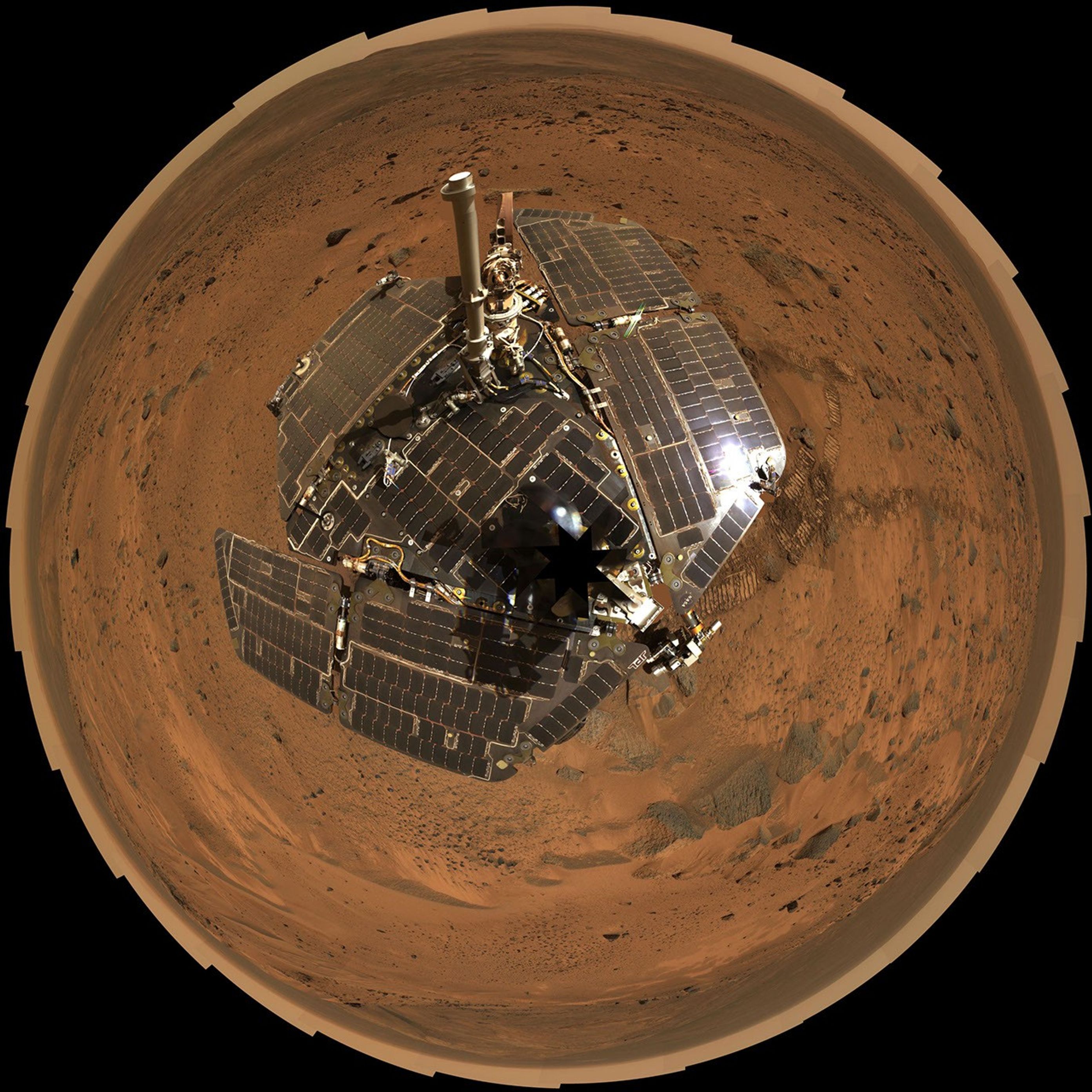 This bird's-eye view combines a self-portrait of the spacecraft deck and a panoramic mosaic of the Martian surface as viewed by the Spirit rover.