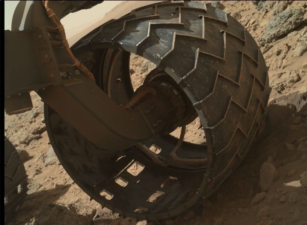 The left-front wheel of NASA's Curiosity Mars rover shows dents and holes in this image taken during the 469th Martian day, or sol, of the rover's work on Mars (Nov. 30, 2013).