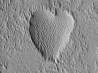 The Mars Global Surveyor (MGS) Mars Orbiter Camera (MOC) took this image in October, 2002. This richly textured heart is a depression located in the Tharsis region, home to massive, ancient volcanoes on Mars.