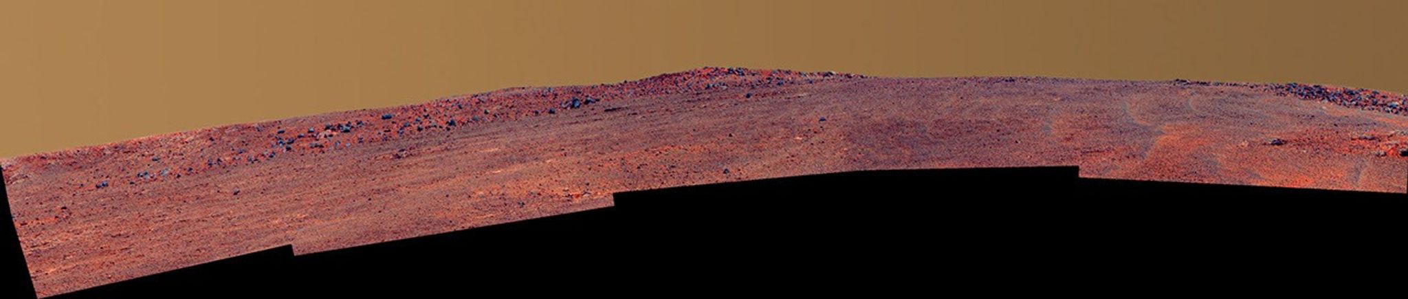 The boulder-studded ridge in this scene recorded by NASA's Mars Exploration Rover Opportunity is "McClure-Beverlin Escarpment," informally named for Jack Beverlin and Bill McClure, engineers who on Feb. 14, 1969, risked their lives to save NASA's second successful Mars mission, Mariner 6, on its launch pad.