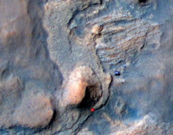 In this Mars Reconnaissance Orbiter view of the Curiosity rover mission's waypoint called "the Kimberley," the red dot indicates the location of a sandstone target, "Windjana," selected for close-up inspection. The