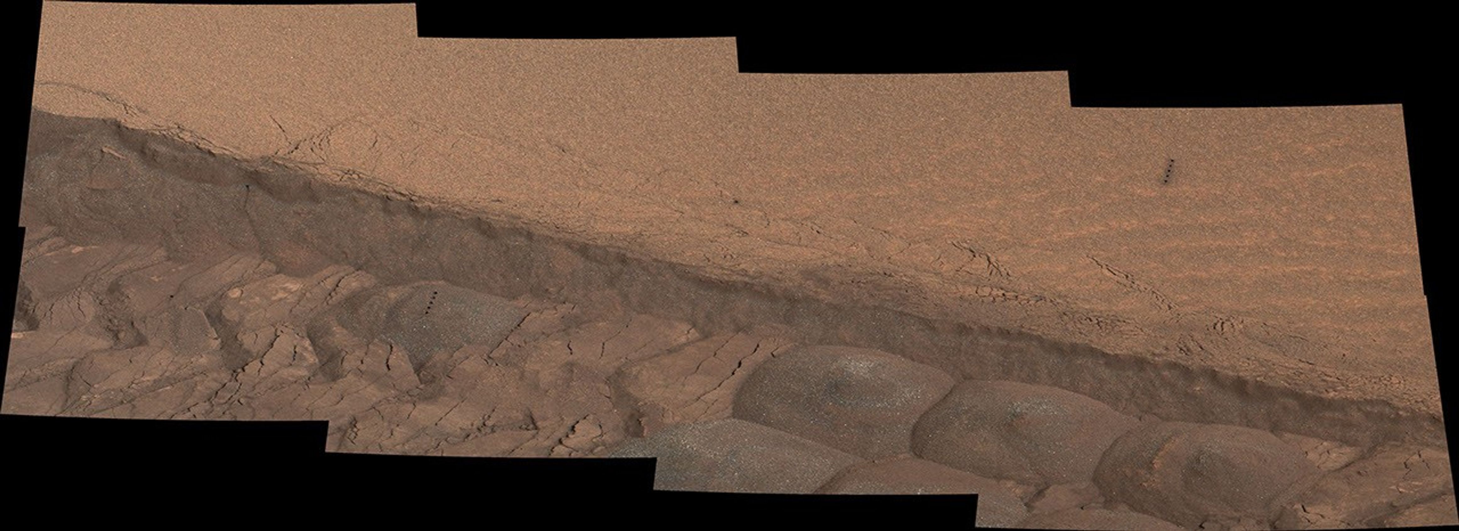 A wheel track cuts through a windblown ripple of dusty sand in this Nov. 7, 2014, image from the Mastcam on NASA's Curiosity rover. The view spans about four feet across. This experiment was planned for yielding a view of the inside of the ripple for assessment of particle sizes and composition.