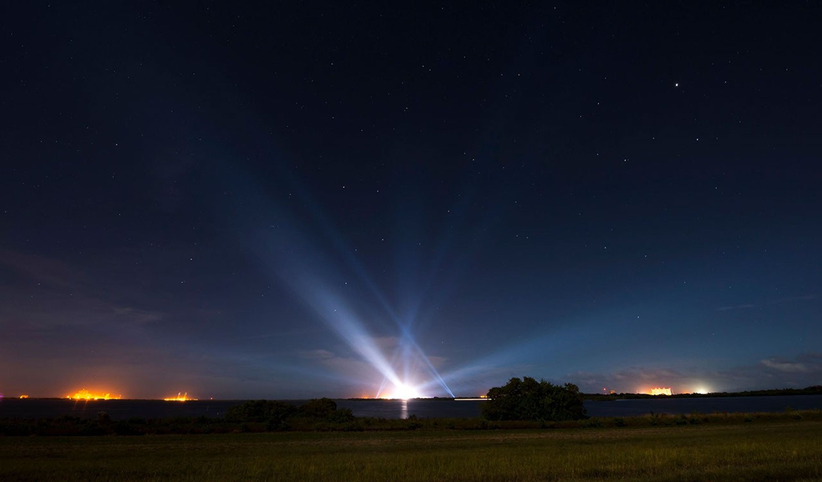 A United Launch Alliance Delta IV Heavy rocket with NASA's Orion spacecraft mounted atop is seen illuminated in the distance in this long exposure photograph taken early today, at Cape Canaveral Air Force Station's Space Launch Complex 37, Florida.