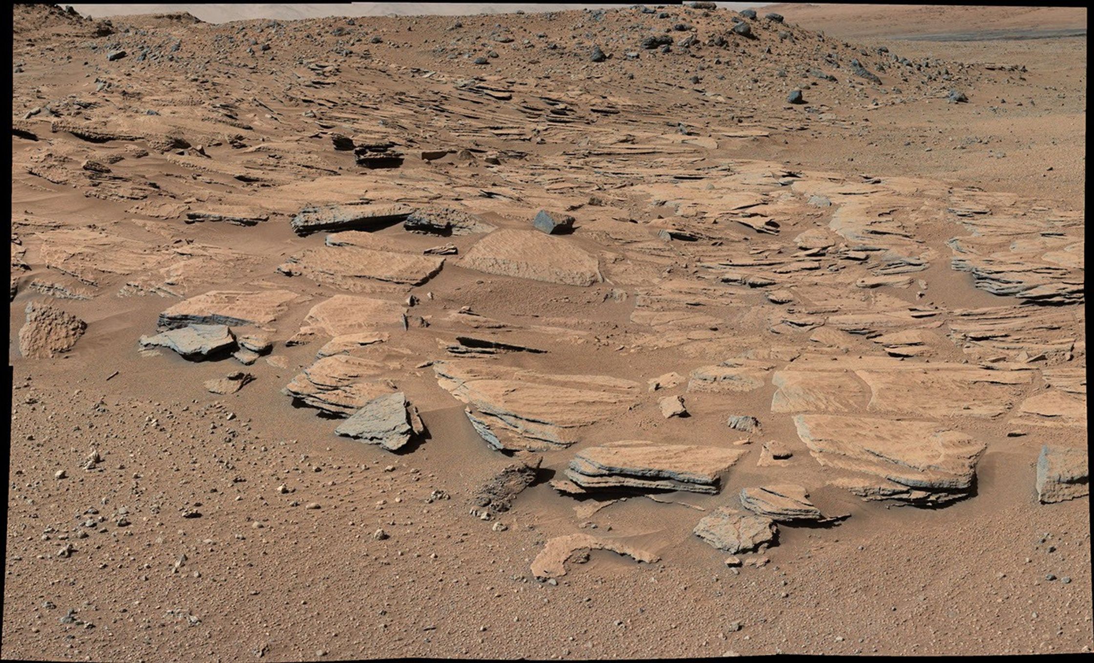 This image from Curiosity's Mastcam shows inclined beds of sandstone interpreted as the deposits of small deltas fed by rivers flowing down from the Gale Crater rim and building out into a lake where Mount Sharp is now.  It was taken March 13, 2014, just north of the "Kimberley" waypoint.