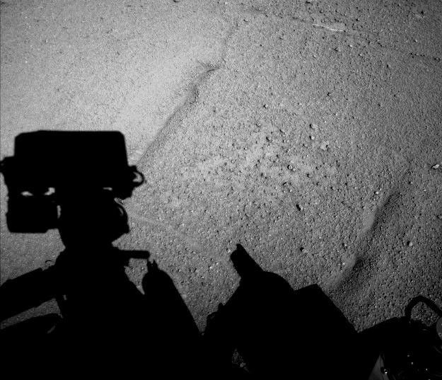 NASA's Curiosity Mars rover caught its own shadow in this image taken just after completing a drive of 329 feet (100.3 meters) on the 547th Martian day, or sol, of the rover's work on Mars (Feb. 18, 2014).