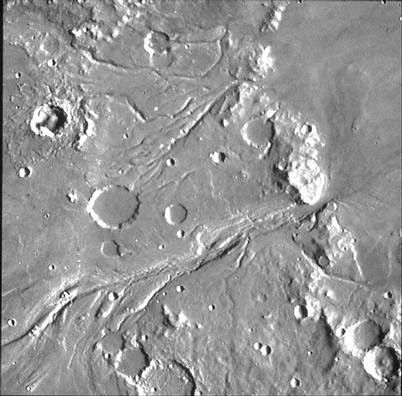 The channel system in the upper half of the image is Maja Valles. The channels appear to have been carved by flowing water released from Juventae Chasma a chaotic depression that is located several hundred kilometers to the south.