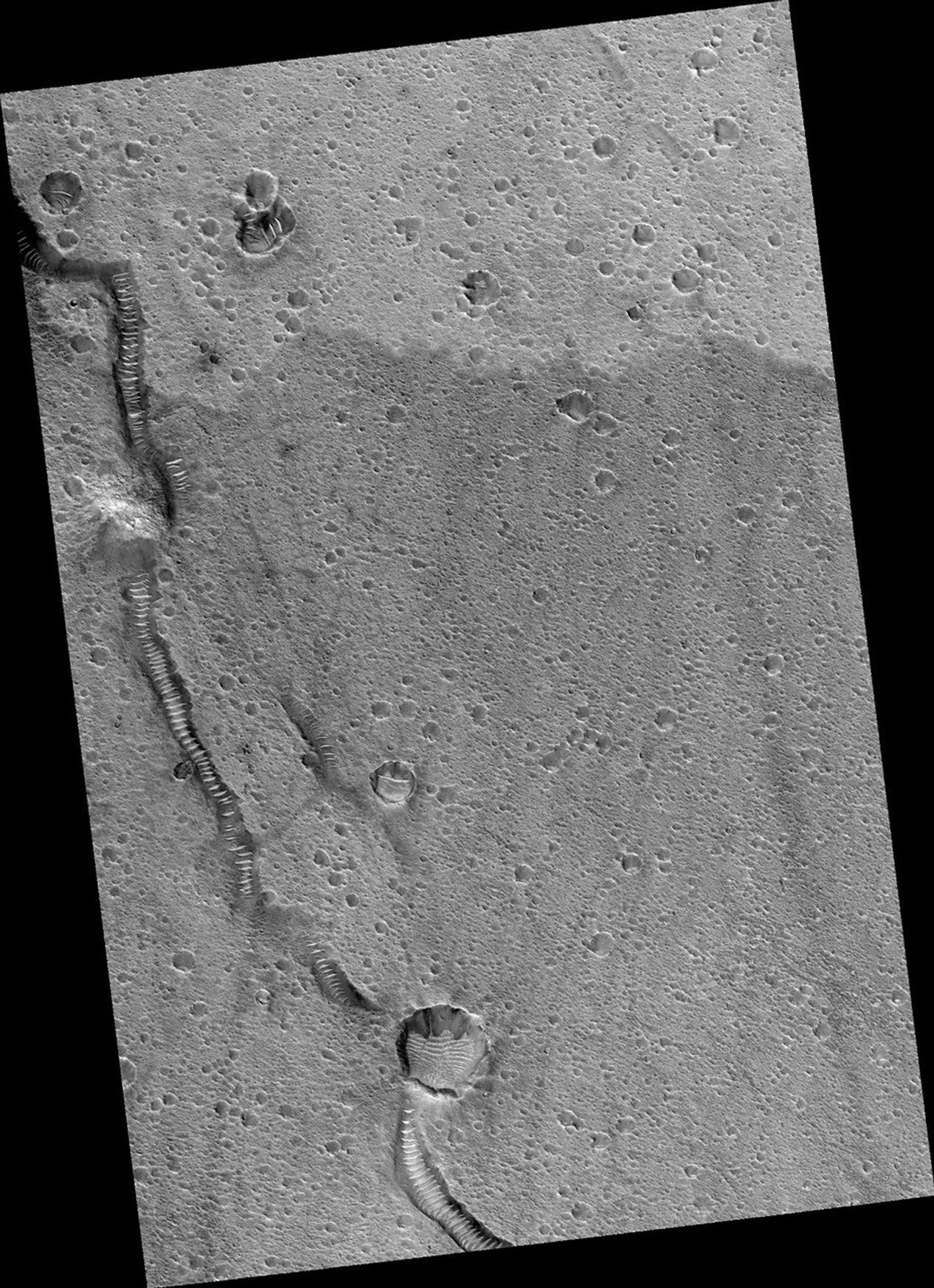This image shows part of the surface of Chryse Planitia, near the mouth of several of the giant outflow channels carved by massive floods. At this location the channel is much too large to be seen within a HiRISE image, and this shows an area of level plains near the mouth.