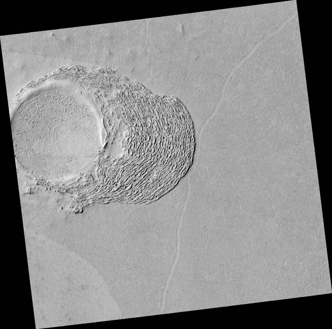 This image shows lava crumpled against the upstream side of an impact crater.