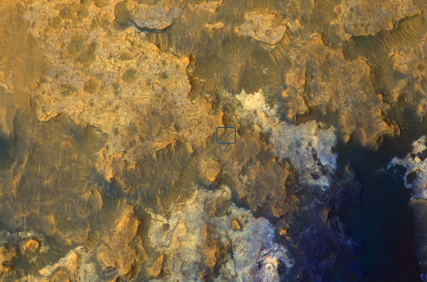 A view from NASA's Mars Reconnaissance Orbiter on April 8, 2015, catches sight of NASA's Curiosity Mars rover passing through a valley called "Artist's Drive" on the lower slope of Mount Sharp.