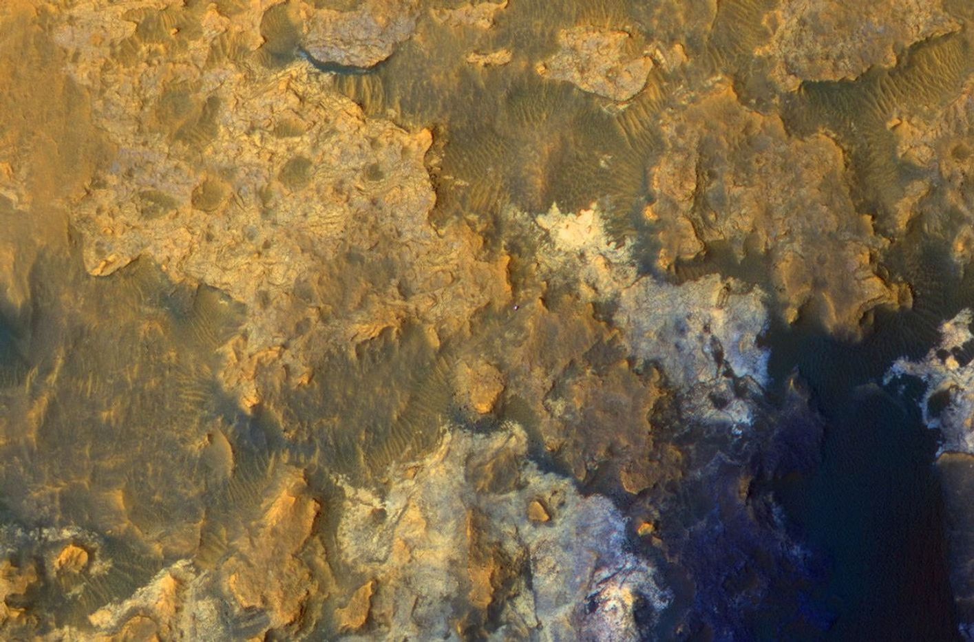 A view from NASA's Mars Reconnaissance Orbiter on April 8, 2015, catches sight of NASA's Curiosity Mars rover passing through a valley called "Artist's Drive" on the lower slope of Mount Sharp.