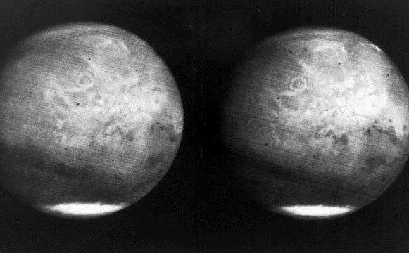 View of the entire planet of Mars from Mariner 7, showing NIX Olympia (later identified as the giant shield volcano Olympus Mons), and polar caps.