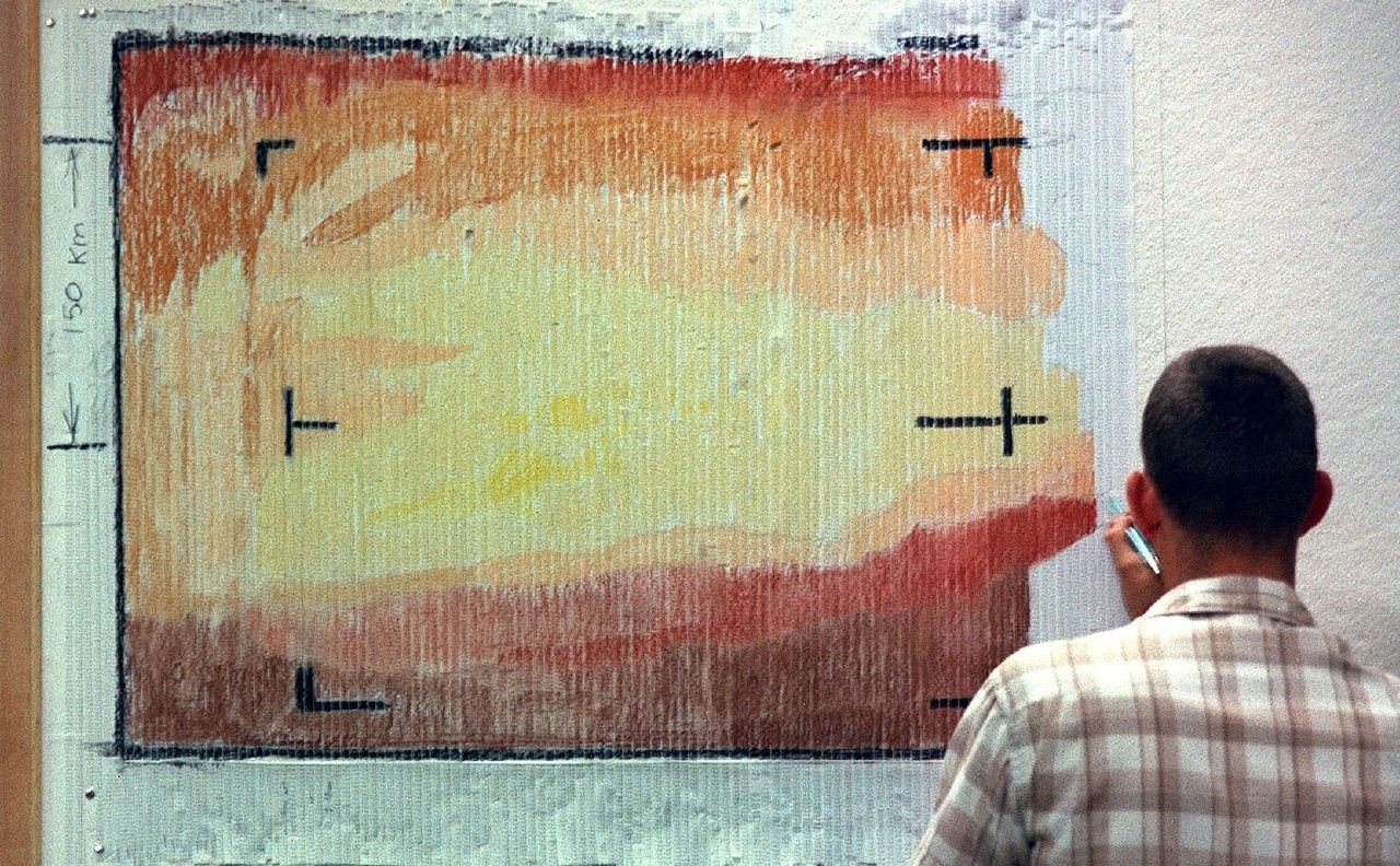 Telecommunications engineers at the Jet Propulsion Laboratory created a color version of one of the first images of Mars by hand-coloring numbered paper strips. Numbers on the strips corresponded to the brightness level of the image.