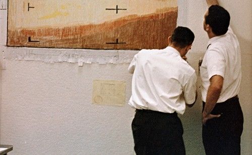 Telecommunications engineers at the Jet Propulsion Laboratory putting the finishing touches on their color-by-number version of Mariner 4's digital data.