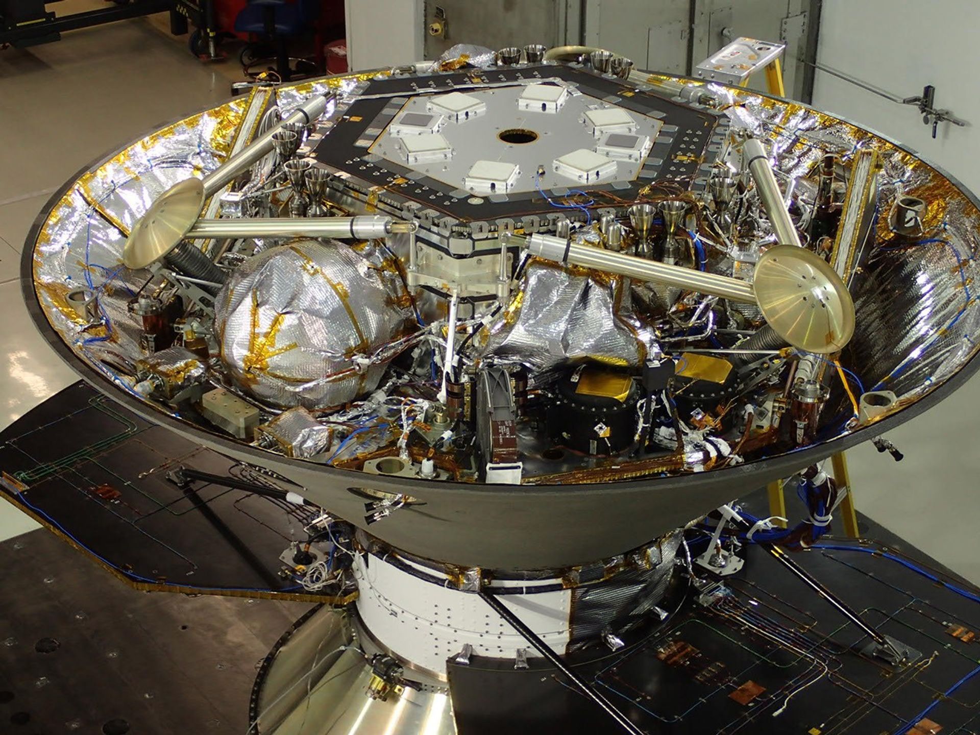 In this photo, NASA's InSight Mars lander is stowed inside the inverted back shell of the spacecraft's protective aeroshell.  It was taken on July 13, 2015, in a clean room of spacecraft assembly and test facilities at Lockheed Martin Space Systems, Denver, during preparation for vibration testing of the spacecraft.