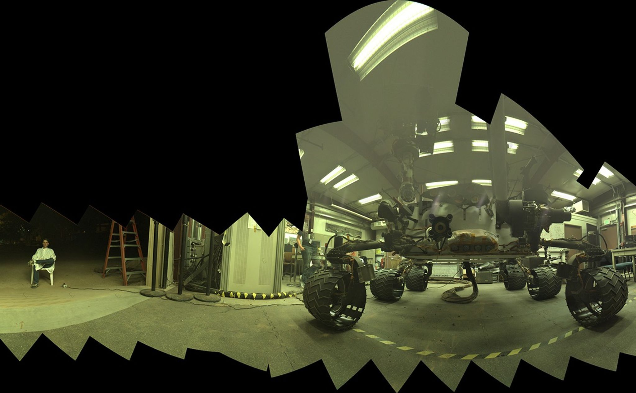This view of a test rover at NASA's Jet Propulsion Laboratory in California results from advance testing of arm positions and camera pointings for taking a low-angle selfie of NASA's Curiosity Mars rover. The rehearsal led to a dramatic Aug. 5, 2013, selfie of Curiosity by the rover's MAHLI camera.