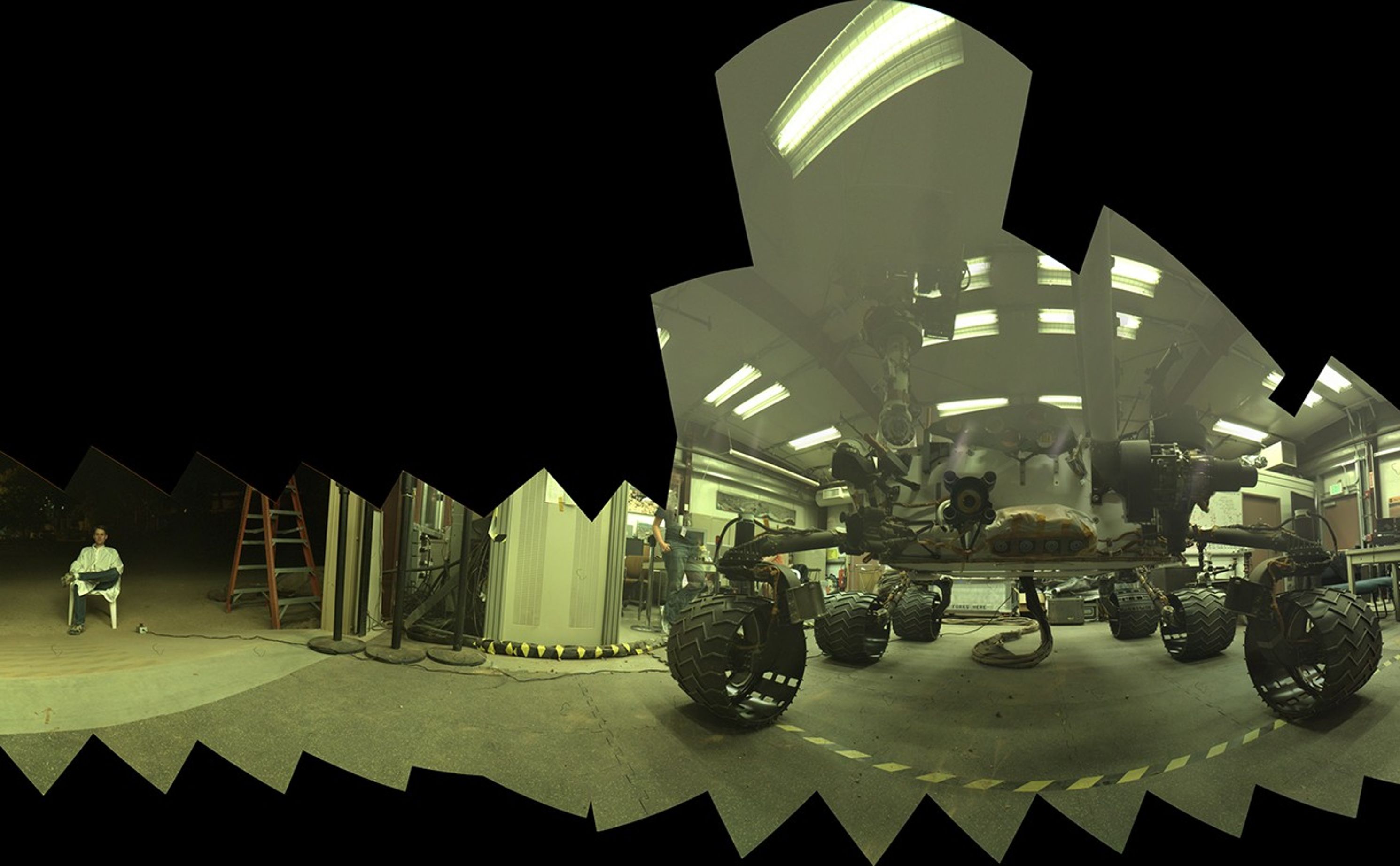 This view of a test rover at NASA's Jet Propulsion Laboratory in California results from advance testing of arm positions and camera pointings for taking a low-angle selfie of NASA's Curiosity Mars rover. The rehearsal led to a dramatic Aug. 5, 2013, selfie of Curiosity by the rover's MAHLI camera.