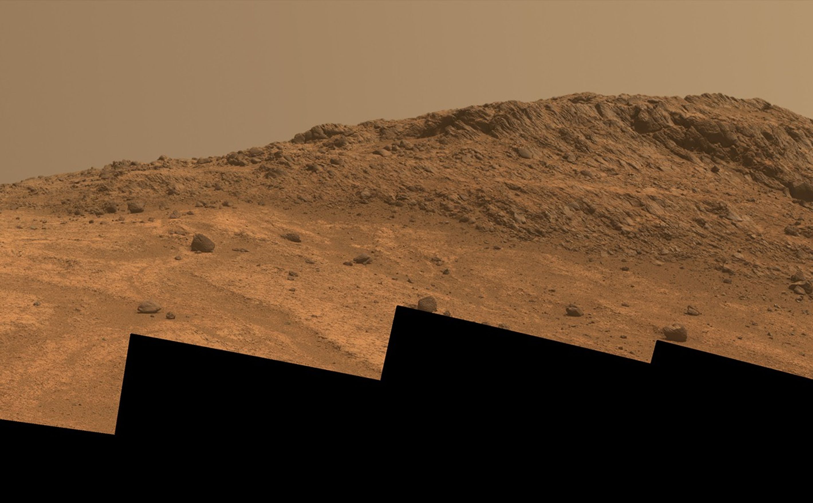 This Martian scene shows contrasting textures and colors of "Hinners Point," at the northern edge of "Marathon Valley," and swirling reddish zones on the valley floor to the left.