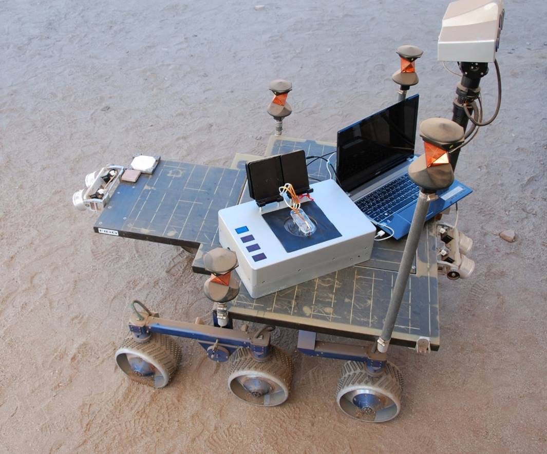 Researchers took the Chemical Laptop to JPL's Mars Yard, where they placed the device on a test rover. This image shows the size comparison between the Chemical Laptop and a regular laptop.