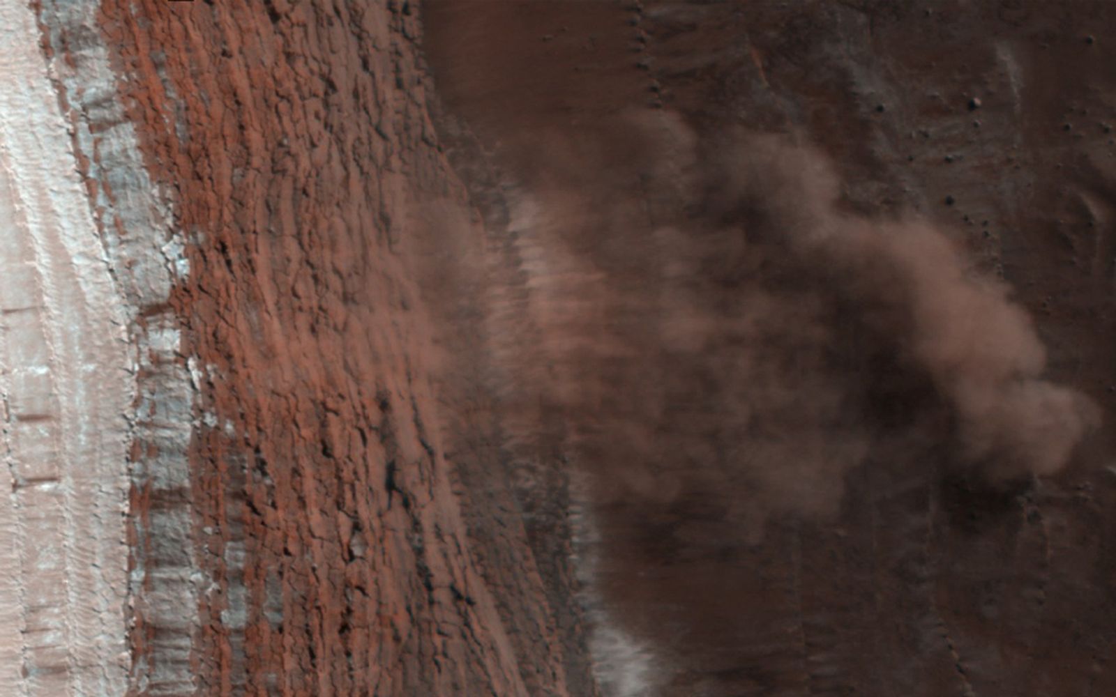 Amazingly, this HiRISE image has captured at least four avalanches, or debris falls, in action.