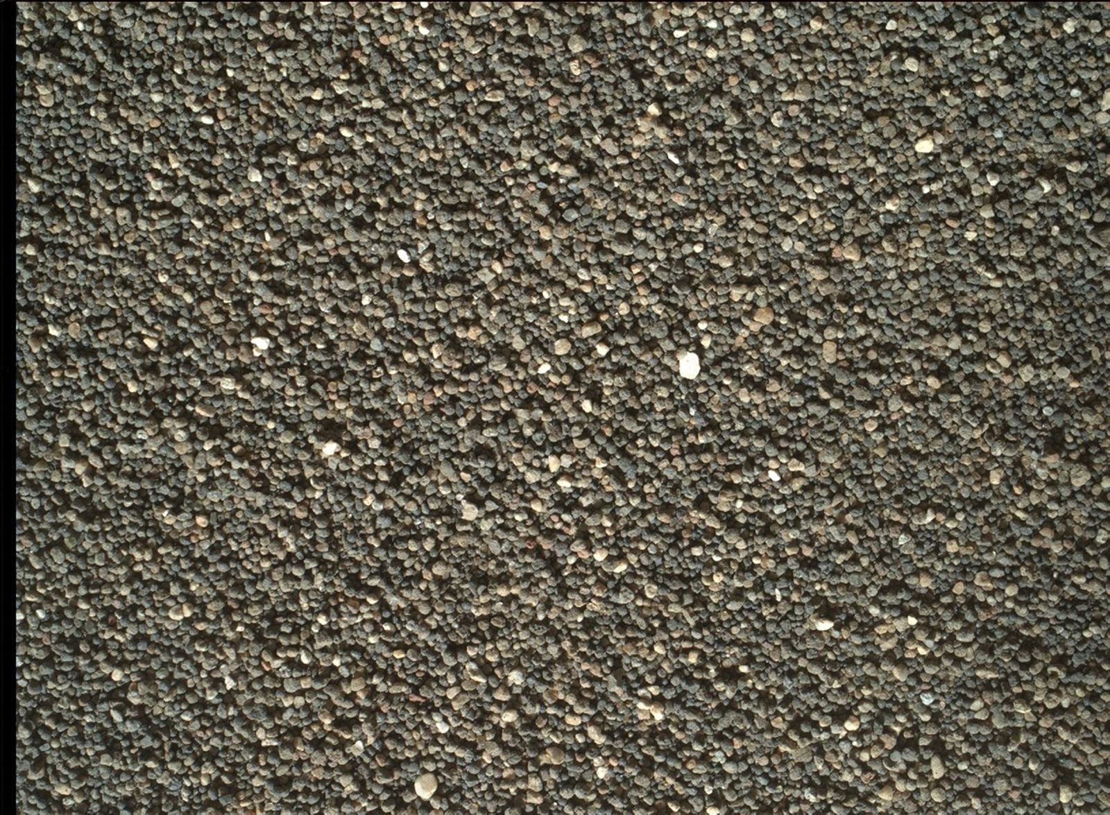 This Dec. 5, 2015, view of the undisturbed surface of a Martian sand dune called "High Dune" shows coarse grains remaining on the surface after wind removal of smaller particles. The image covers an area 1.4 inches across. It was taken by the rover's Mars Hand Lens Imager (MAHLI).