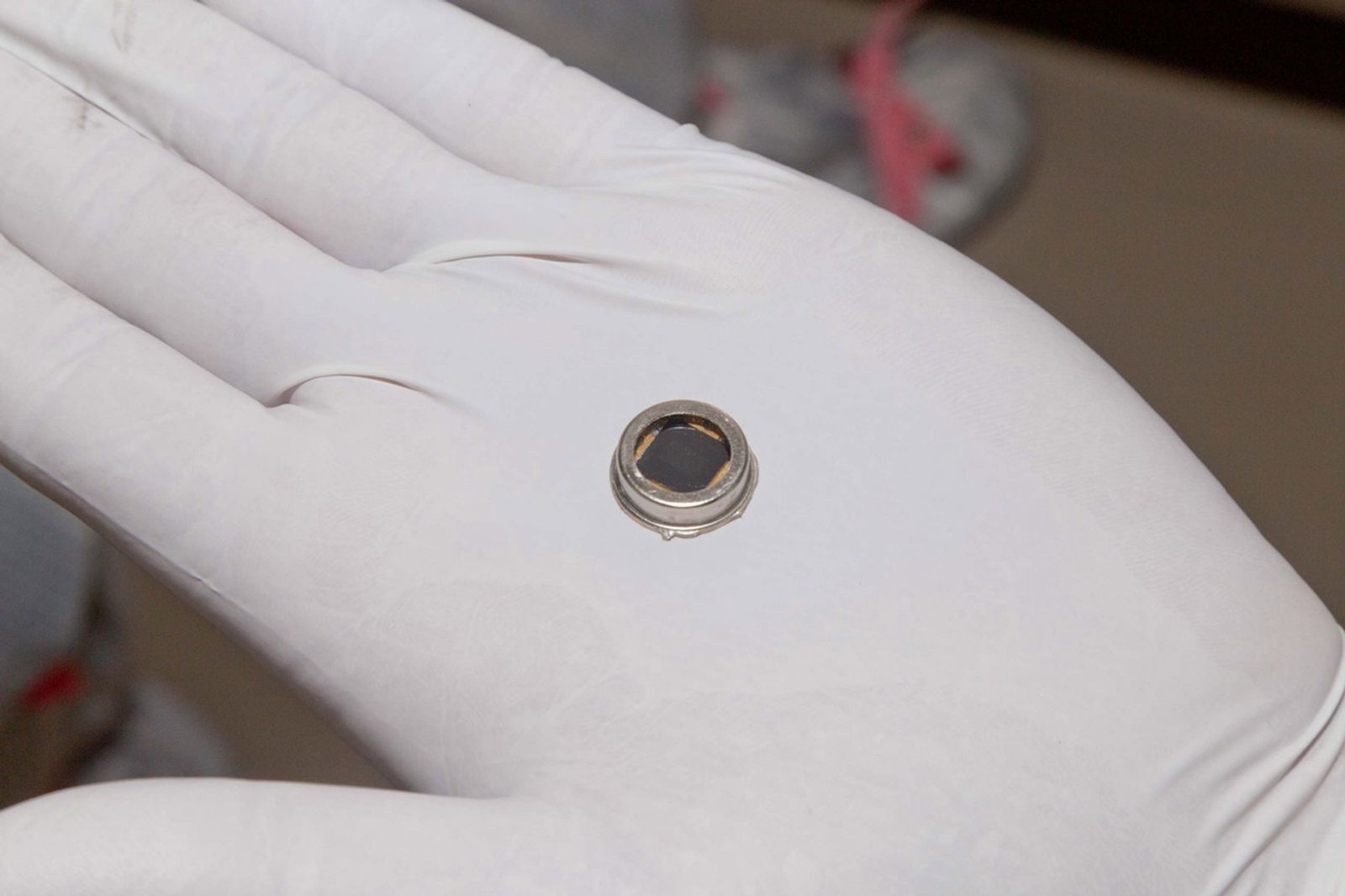 The dime-size microchip in this close-up image carries 826,923 names that will go to Mars on NASA's InSight lander.