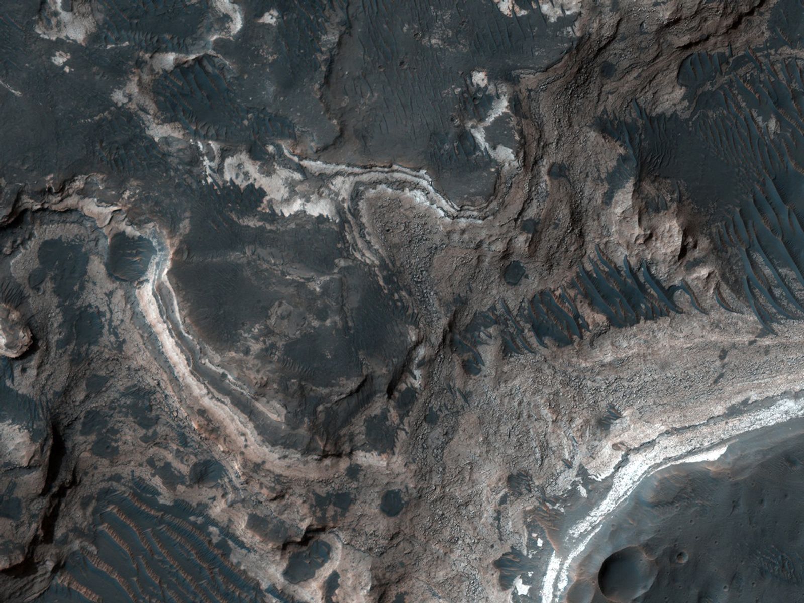 This HiRISE image covers the southwest portion of the terraces and floor of Holden Crater situated in southwest Margaritifer Terra.