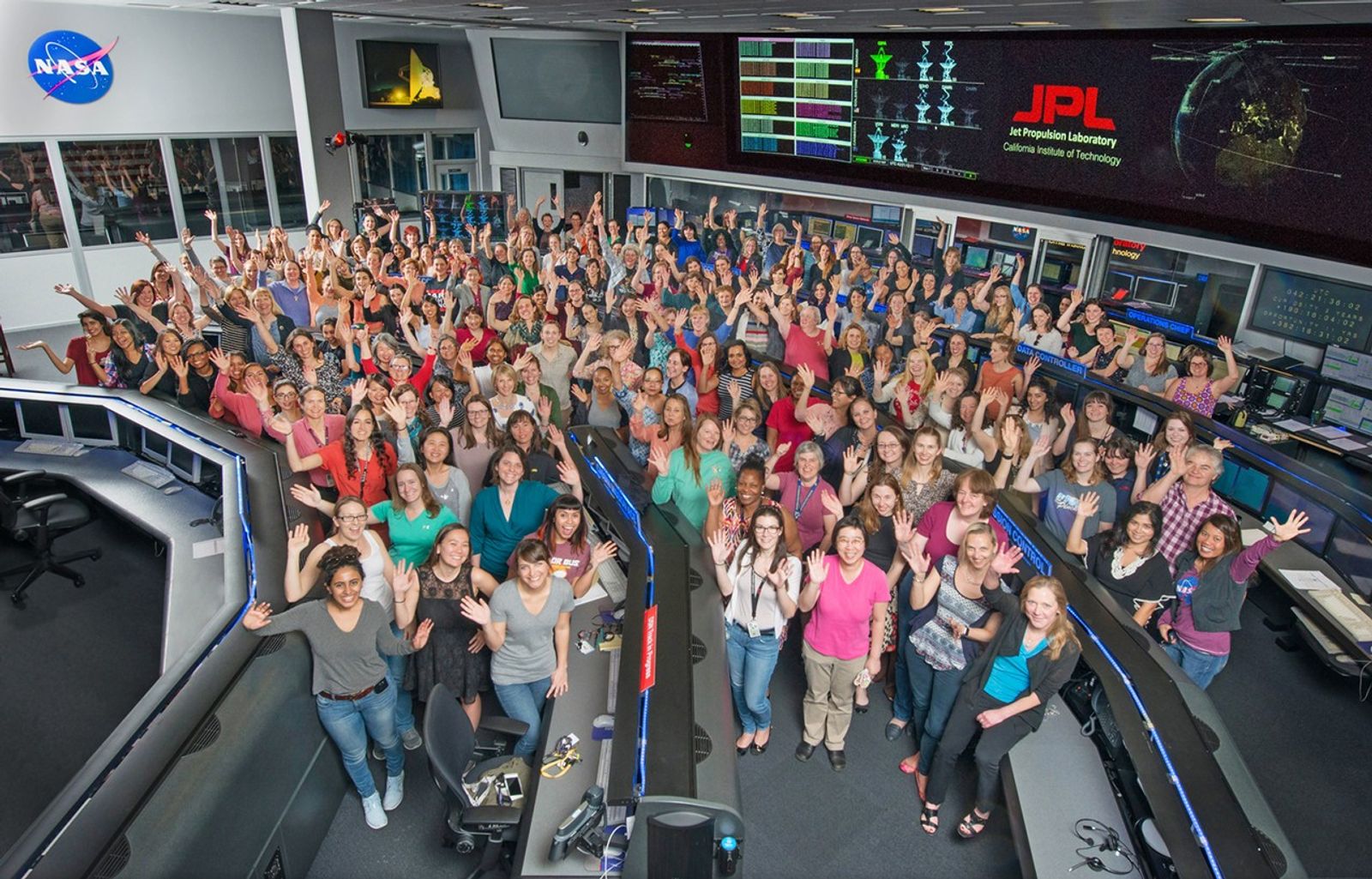 Women working in science, technology, engineering and mathematics at NASA's Jet Propulsion Laboratory pose for a photo in mission control in honor of Women in Science Day.