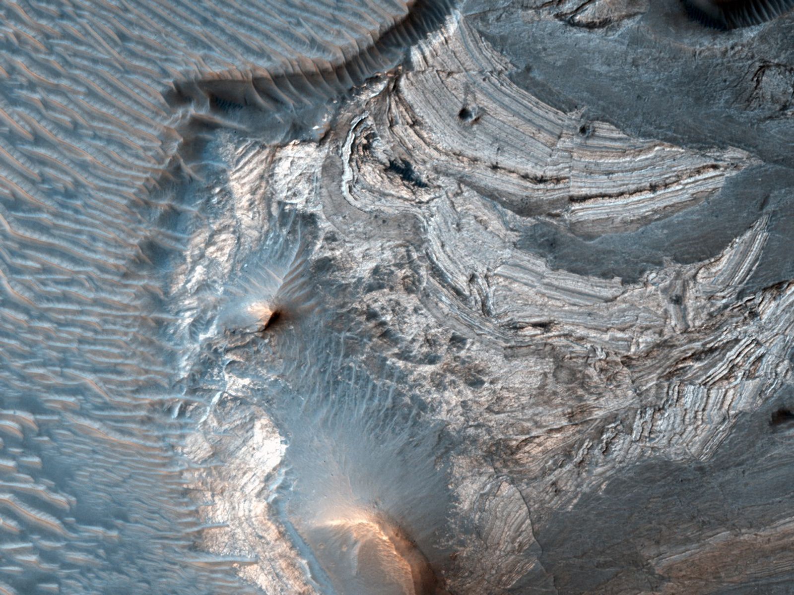 The rock layers in this image were likely horizontal when the materials were first deposited, but are now tilted to high angles, approaching 90 degrees.