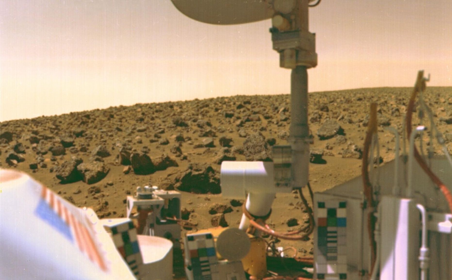 The boulder-strewn field of red rocks reaches to the horizon nearly two miles from Viking 2 on Mars' Utopian Plain.