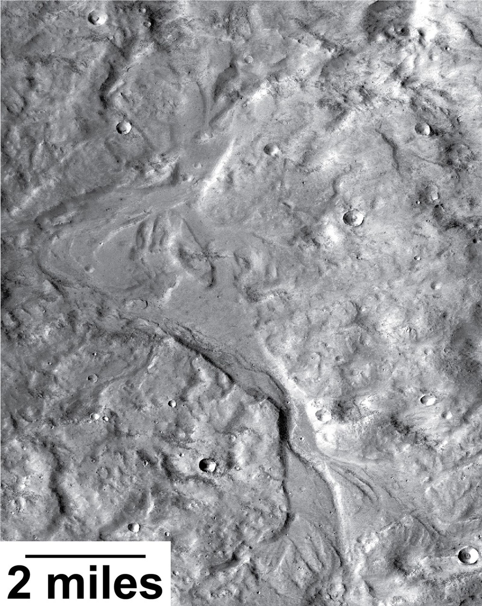 Streamlined forms in this Martian valley resulted from the outflow of a lake hundreds of millions years more recently than an era of Martian lakes previously confirmed. This image from the Context Camera on NASA's Mars Reconnaissance Orbiter covers an area in Arabia Terra about 8 miles wide.