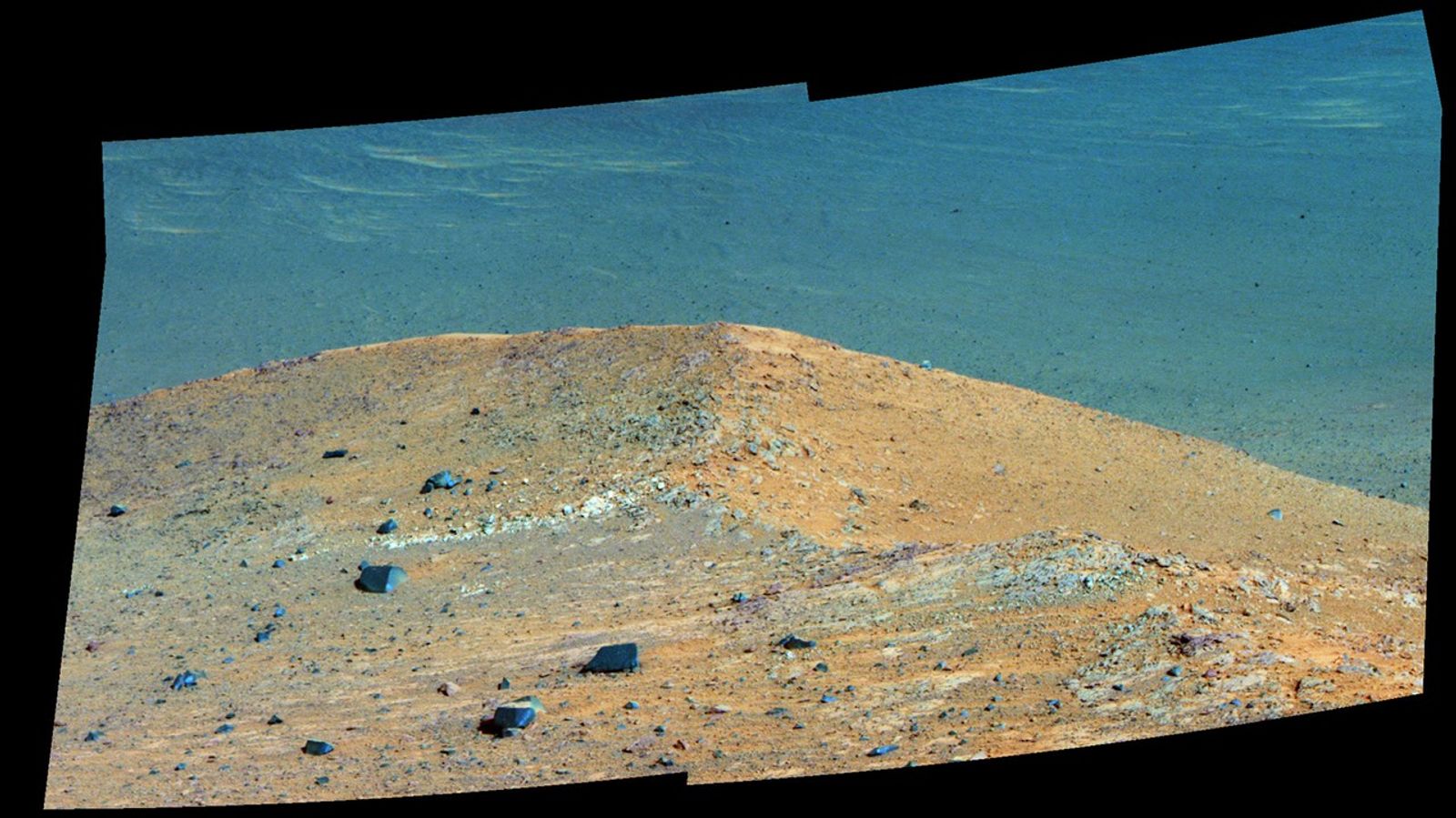 This Sept. 21, 2016, scene from the panoramic camera (Pancam) on NASA's Mars Exploration Rover Opportunity shows "Spirit Mound" overlooking the floor of Endeavour Crater. The mound stands near the eastern end of "Bitterroot Valley" on the western rim of the crater, and this view faces eastward.
