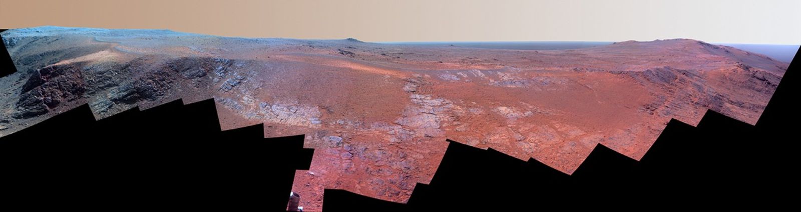 A grooved ridge called "Rocheport" on the rim of Mars' Endeavour Crater spans this scene from the Pancam on NASA's Mars rover Opportunity. This version of the scene is presented in enhanced color to make differences in surface materials more easily visible.