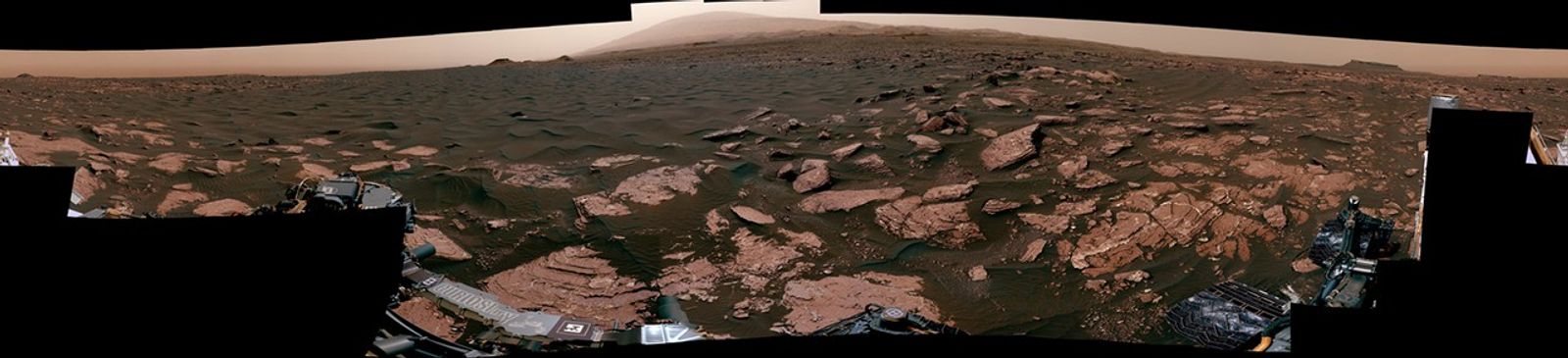 This 360-degree scene from the Mastcam on NASA's Curiosity Mars rover includes part of a linear-shaped dune the rover examined in early 2017 for comparison with what it found previously at crescent-shaped dunes. The view shows the dark, rippled surface of the active dune, near sedimentary bedrock.