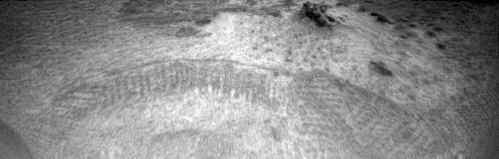 Tracks made by NASA's Sojourner rover are visible in this image, taken by one of the cameras aboard Sojourner on July 6, 1997. The tracks represent the rover maneuvering towards the rock dubbed Barnacle Bill.