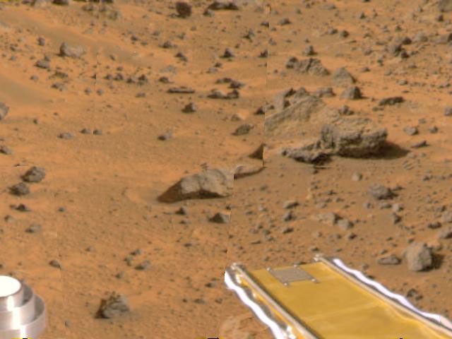 Mars Pathfinder's forward rover ramp can be seen successfully unfurled in this color image, taken at the end of July 6, 1997 by the NASA's Imager for Mars Pathfinder (IMP). he square at the end of the ramp is one of the spacecraft's magnetic targets.