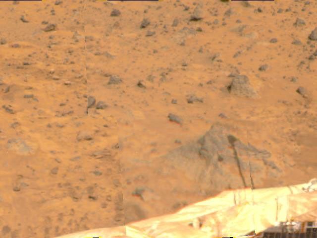 A shadow of the Atmospheric Structure Instrument/Meteorology Package (ASI/MET) has been cast on a rock at right in this image, taken by NASA's Imager for Mars Pathfinder (IMP) on July 8, 1997.