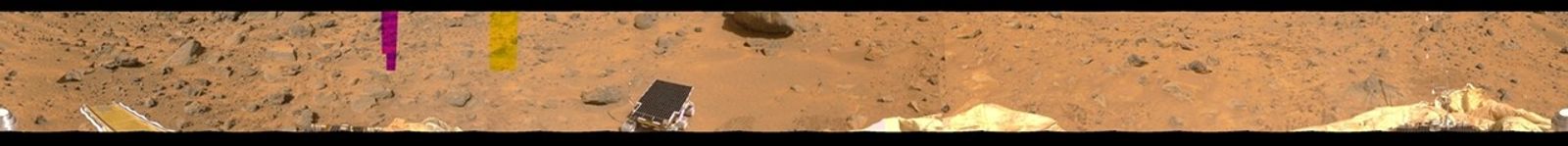 This image represents the first two tiers of a 360-degree color panorama, taken by NASA's Imager for Mars Pathfinder (IMP) on July 9, 1997. At left, the forward ramp is visible near the larger rocks.