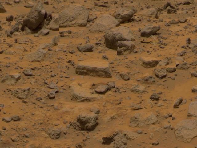 Taken by NASA's Imager for Mars Pathfinder (IMP), this image shows the rock dubbed 'Flat Top' at center. Dust has accumulated on the top of Flat Top, but is not present on the sides due to the steep angles of the rock.