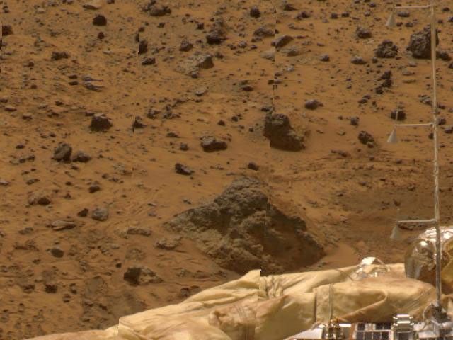 The Atmospheric Structure Instrument/Meteorology Package (ASI/MET) mast is visible against a backdrop of rocky Martian terrain in this image, taken by NASA's Imager for Mars Pathfinder (IMP). Sol 1 began on July 4, 1997.