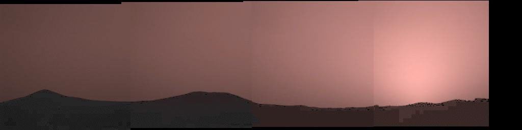 This image was taken by the Imager for NASA's Mars Pathfinder about one minute after sunset on Mars on Sol 21. The prominent hills dubbed 'Twin Peaks' form a dark silhouette at the horizon, while the setting sun casts a pink glow over the darkening sky.