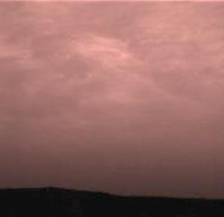 Pink stratus clouds are coming from the northeast at about 15 miles per hour at an approximate height of ten miles above the surface. The image was taken by NASA's Imager for Mars Pathfinder (IMP) on Sol 16. Sol 1 began on July 4, 1997.