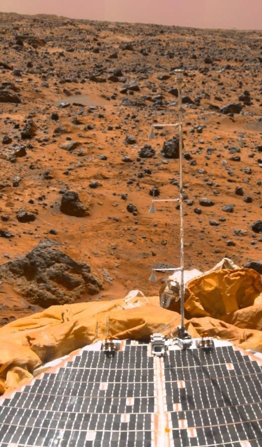 NASA's Mars Pathfinder meteorology mast casts a shadow on the lander solar array, as seen in this superpan mosaic taken in 1997.