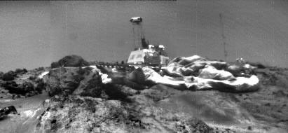 Image of NASA's Pathfinder Lander on Mars taken from Sojourner Rover left front camera on sol 33. The IMP (on the lattice mast) is looking at the rover. Airbags are prominent, and the meteorology mast is shown to the right. Sol 1 began on July 4, 1997.