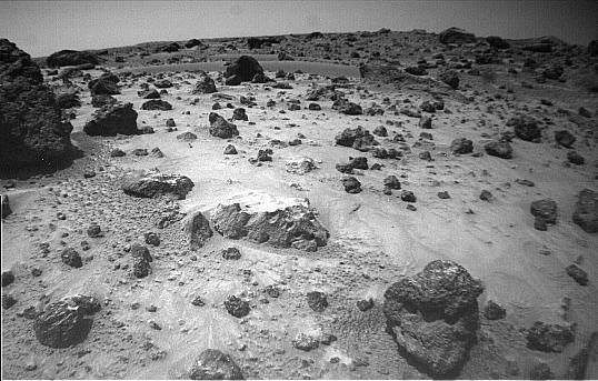 NASA's Mars Pathfinder's rover Sojourner imaged this area of Martian terrain on Sol 26, 1997. The large rock dubbed 'Pooh Bear' is at far left. 'Mermaid Dune' is the smooth area stretching horizontally across the top quarter of the image.