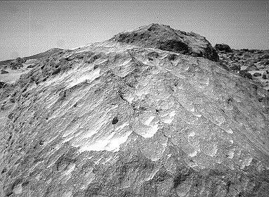 A close-up view of the rock 'Moe' in the 'Rock Garden' at the Pathfinder landing site. Moe is a meter-size boulder that, as seen NASA's Sojourner, has a relatively smooth yet pitted texture upon close examination. Sol 1 began on July 4, 1997.